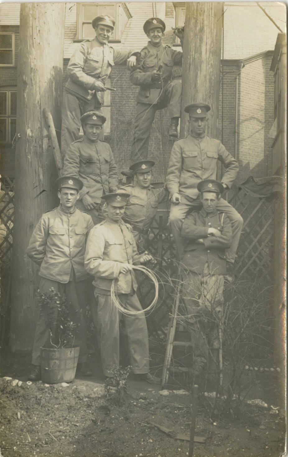 Real photo black and white postcard depicting a group of telephone linemen on the front.